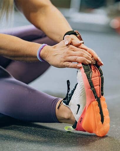 Woman doing stretching exercise at Yankee Echo Alpha Fitness